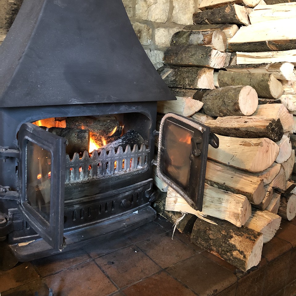 A glowing wood burner at The Shoulder of Mutton